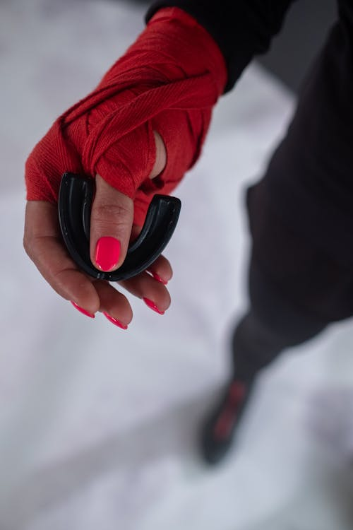  An image of a person holding a mouthguard in the hand 